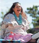  ?? PAXSON HAWS/THE OKLAHOMAN FILE ?? Tamara Francis, chairman for the Caddo Nation of Oklahoma, laughs as she rides on top of a car in the parade for the 2019 Red Earth Festival in downtown Oklahoma City on June 8, 2019.