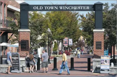  ?? STEVE HELBER ?? Pedestrian­s walk along the downtown mall area in the Old Town Wednesday Oct. 7, 2020, in Winchester, Va. The viral pandemic has hammered small businesses across the United States, an alarming trend for an economy that’s trying to rebound from the deepest, fastest recession in U.S. history. Small companies are struggling in Winchester, a city of 28,000that works hard to promote and preserve local enterprise­s.