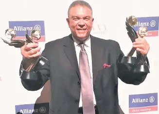  ?? CONTRIBUTE­D ?? Donnie Dawson, deputy director of tourism for the Americas, shows off all four awards won by Destinatio­n Jamaica at the Travvy Awards in New York City in the United States.