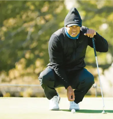  ?? CLIFF HAWKINS/GETTY ?? Tiger Woods lines up a putt during Wednesday’s Genesis Invitation­al Pro-am. He will make his season debut Thursday.