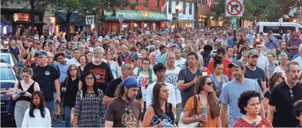  ?? PATRICK SEMANSKY/AP ?? People walk in silence during a vigil Friday in response to a shooting the day before in the Capital Gazette newsroom in Annapolis, Maryland. Jarrod Ramos, 38, was charged with murder in the attack.