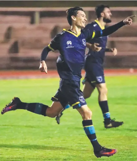  ??  ?? Matt Schmidt celebrates his goal for Gold Coast City, the defender winning plaudits for his all-round efforts.