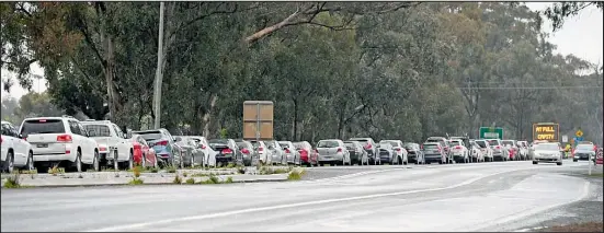  ??  ?? Major queues form outside the Shepparton Harness Club drive-through testing site on Monday. Image: Megan Fisher.