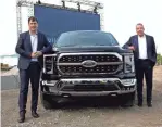  ?? ERIC SEALS/DETROIT FREE PRESS ?? From left, Ford CEO Jim Farley and Bill Ford Jr., executive chairman, stand beside a new 2021 Ford F-150. Trucks built early are stockpiled near Metro Airport and are undergoing a final assessment.