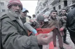  ?? Picture: REUTERS ?? HURT: Men help a wounded person after a missile hit Aleppo's alMashhad district on Monday.