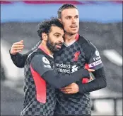 ??  ?? Liverpool's midfielder Mohamed Salah (L) celebrates with mid-fielder Jordan Henderson