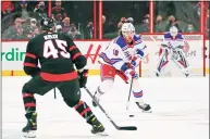  ?? Sean Kilpatrick / Associated Press ?? New York Rangers left wing Artemi Panarin (10) skates the puck up ice as Ottawa Senators center Parker Kelly (45) skates backward during the first period on Saturday.