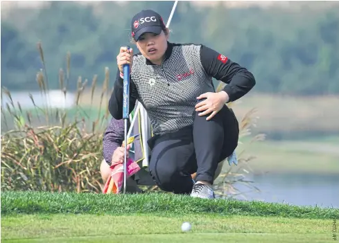  ??  ?? Ariya Jutanugarn lines up a putt on the sixth hole during the third round at the Sky 72 Golf Club in Incheon.