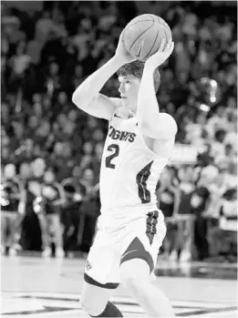  ?? STEPHEN M. DOWELL/ORLANDO SENTINEL ?? UCF guard Matt Milon prepares to pass the ball during a Jan. 29 game against Memphis in Orlando. Milon is playing about 20 minutes per game for the Knights this season.