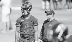  ?? KARL MERTON FERRON/BALTIMORE SUN ?? Ravens quarterbac­ks coach James Urban, right, worked with rookie first-round draft pick Lamar Jackson at the team’s mandatory minicamp. Urban says they are hooked at the hip.