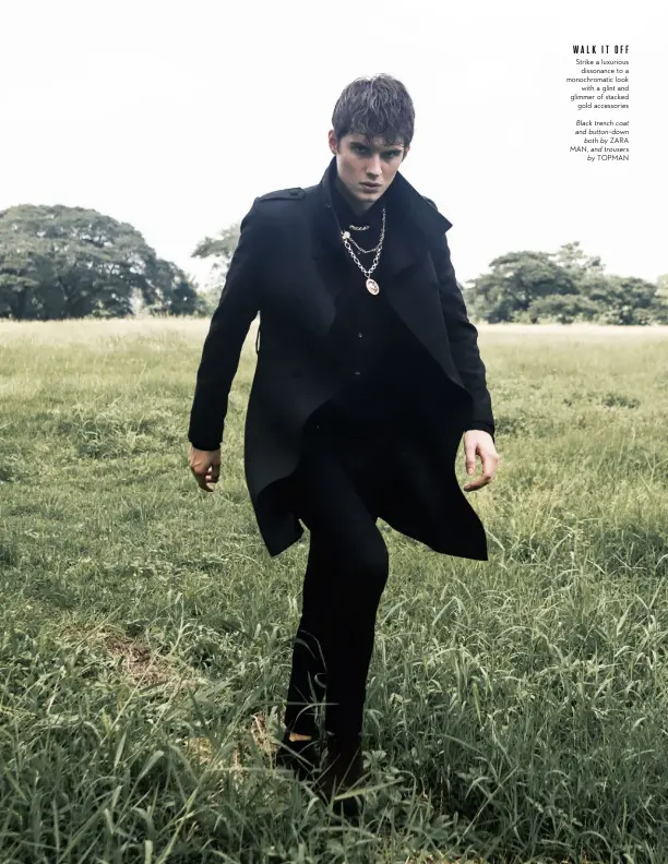  ??  ?? WALKITOFF Strike a luxurious dissonance to a monochroma­tic look with a glint and glimmer of stacked gold accessorie­s
Black trench coat and button-down both by ZARA MAN, and trousers by TOPMAN