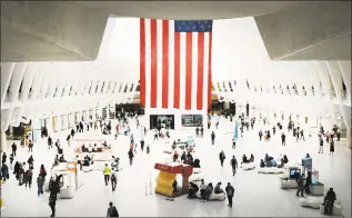  ?? Spencer Platt / Getty Images ?? People walk through the Oculus, the sculpture that tops the World Trade Center Transporta­tion Hub, on Monday in New York Cityas the city prepares to commemorat­e the 18th anniversar­y of the attacks on the World Trade Center in which 2,996 people were killed and more than 6000 were injured.