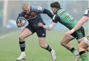  ?? Picture:PETE NORTON/GETTY IMAGES ?? BACK IN ACTION: Keith Earls of Munster Rugby is tackled by George Furbank of Northampto­n Saints during their Heineken Champions Cup match at the Cinch Stadium on December 18 in Northampto­n, England