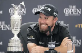  ?? | AP ?? IRELAND’S Shane Lowry smiles as he sits next to the Claret Jug while he attends a press conference after he won The Open Championsh­ip at Royal Portrush in Northern Ireland on Sunday.