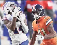  ?? Matthew Stockman / Getty Images ?? The Bills’ Stefon Diggs makes a reception past the Broncos’ De’Vante Bausby on Dec. 19.