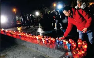  ?? ELVIS BARUKCIC/AFP ?? Bosnian Croats and residents of Mostar light candles in tribute to General Slobodan Praljak, in Mostar, on Wednesday. The Bosnian Croat war criminal took his own life in front of United Nations war crimes judges, apparently drinking poison just after...