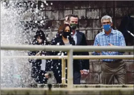  ?? JACQUELYN MARTIN — THE ASSOCIATED PRESS ?? Vice President Kamala Harris and Gov. Gavin Newsom tour a water treatment plant in Oakland Monday with David Briggs, right, operations director of the East Bay Municipal Utility District.