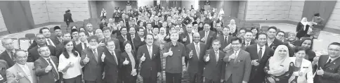  ??  ?? Mah (centre) in a group photo with his ministry staff. — Bernama photo