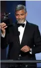  ?? — AFP ?? George Clooney with the 46th American Film Institute Life Achievemen­t Award in Hollywood on Thursday.