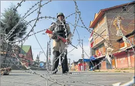  ?? AP ?? A paramilita­ry soldier stands guard at a temporary check point during restrictio­ns in Srinagar on Tuesday. Vehicles stayed off the road and shops closed in response to a shutdown called by the Hurriyat Conference, a day after seven Kashmiri separatist­s...