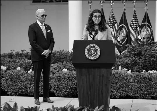  ?? CAROLYN KASTER / ASSOCIATED PRESS FILE ?? President Joe Biden listens as Mia Tretta, a survivor of the Saugus High School shooting in Santa Clarita, Calif., speaks April 11 in the Rose Garden of the White House.