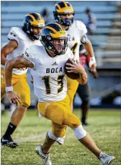  ?? BRUCE R. BENNETT / THE PALM BEACH POST ?? Boca Raton’s Michael Pratt carries the ball during the fifirst half of Thursday night’s high school football game against Santaluces.