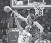  ?? Seth Wenig / Associated Press ?? Just because they’re named the Nets doesn’t mean they can reach them easily, as Brooklyn’s Sean Kilpatrick learns, courtesy of the Rockets’ Nene.