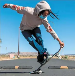  ?? — PAUL MOLINA VIA AP ?? terrill Humeyestew­a performing a trick on a skateboard on the Hopi reservatio­n in northeaste­rn arizona.