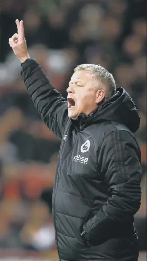  ??  ?? Sheffield United manager Chris Wilder, seen passing on instructio­ns against Fulham, hopes to bring in ‘three or four’ players in January with ‘maybe two or three out’.