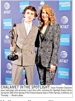  ??  ?? Actor Timothee Chalamet poses backstage with presenter Laura Dern after receiving the Spotlight Award, Actor, during the 30th Palm Springs Film Festival Awards Gala in Palm Springs, California, on Thursday. — Reuters photo