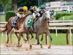  ??  ?? Awesome Debate, with jockey Luis Saez aboard, wins the 18th running of the Union Avenue at Saratoga Race Course on Thursday.