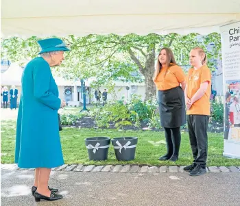  ??  ?? GIFTS: Members of the Children’s Parliament present The Queen with some trees.