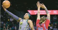  ?? JERRY LARSON/AP ?? Baylor guard Sarah Andrews scores past Delaware State forward McKenzie Stewart on Thursday in Waco, Texas.