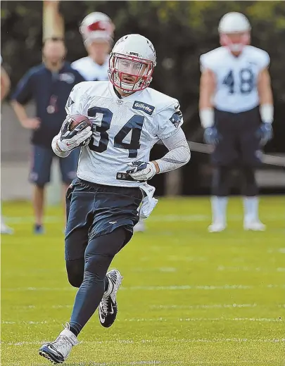  ?? STAFF PHOTO BY MATT STONE ?? IN THE RUNNING: Newcomer Rex Burkhead warms up during practice yesterday at Gillette Stadium. Burkhead is trying to establish himself in a crowded offensive backfield for the Patriots.