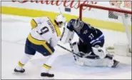  ?? THE ASSOCIATED­L PRESS ?? FILE In this file photo, Winnipeg Jets’ goaltender Connor Hellebuyck (37) makes the game-winning save on Nashville Predators’ Filip Forsberg (9) during the shootout in Winnipeg, Manitoba. The Predators take on the Jets in the Western Conference...