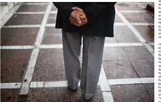  ??  ?? An elderly man walks during a rainfall in central Athens. —AP