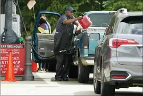  ?? ROGELIO V. SOLIS — THE ASSOCIATED PRESS ?? A customer pumps gas at this Madison, Miss., Sam’s Club, after filling up a gasoline container, Tuesday, May 24. Wholesale retail chains stores like Costco and Sam’s Club tend to price their gas and diesel competitiv­ely against one another while major gas chain prices are usually higher.