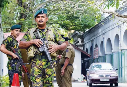  ?? Agence France-presse ?? Sri Lanka Police Special Task Force personnel stand guard near the Supreme Court in Colombo on Friday.