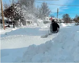 ?? AP ?? Martin Haslinger uses a snowblower outside his home in Buffalo, New York, following a lakeeffect snowstorm. Residents of the northern New York state are digging out from the dangerous snowstorm that had dropped nearly 2m of snow in some areas and caused three deaths.