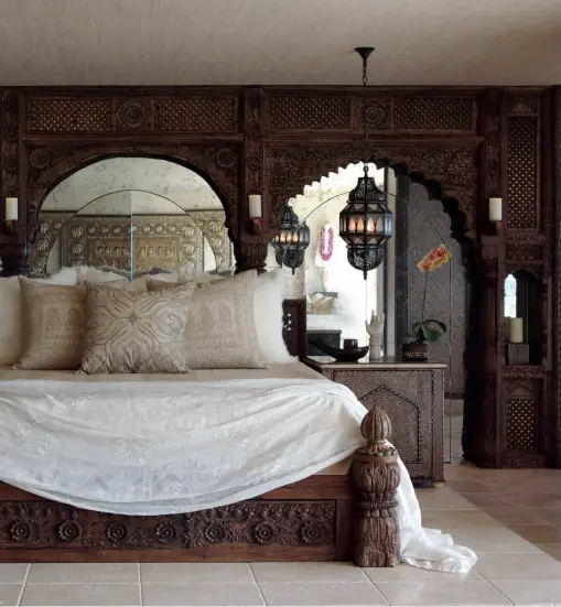  ??  ?? Left, a bedroom that Bullard designed for Cher, which features a bed made from antique Indian panels, placed on a limestone platform. Below, the bathrooms at Sands Hotel &amp; Spa feature Waterworks brass fixtures and Acqua di Parma amenities