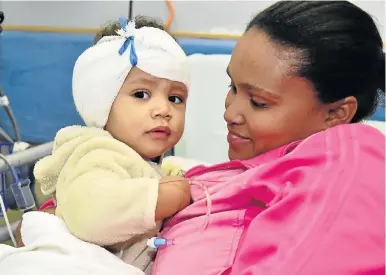  ?? Picture: EUGENE COETZEE ?? NEW JOY: Mom Antoinette comforts little Breyden Marais after his cochlear implant at Port Elizabeth’s Life St George’s Hospital yesterday