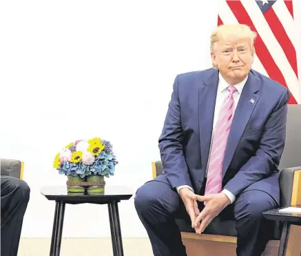  ?? PHOTO: SPUTNIK/ AFP/GETTY ?? Exchange: Vladimir Putin and Donald Trump hold a meeting on the sidelines of the G20 summit in Osaka, Japan yesterday