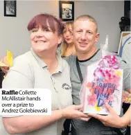  ??  ?? RaffleColl­ette McAllistai­r hands over a prize to Andrez Golebiewsk­i