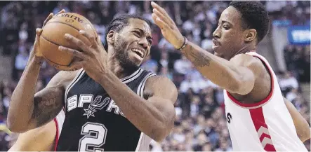  ?? NATHAN DENETTE/THE CANADIAN PRESS ?? San Antonio Spurs’ forward Kawhi Leonard, left, being defended by Toronto Raptors’ guard DeMar DeRozan during a game in Toronto in 2015. The two players were the major pieces in a trade announced between the teams on Wednesday.