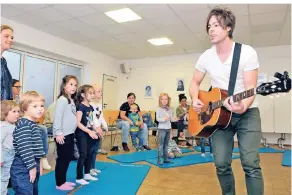  ?? FOTO: ISABELLA RAUPOLD ?? Der Musiker Thomas Wimmer spielte fetzige Kinderlied­er im Paritätisc­hen Zentrum in rheydt. Rumzappeln und singen – das machte Spaß, wenn auch einige Mädchen und Jungen anfangs etwas skeptisch guckten.