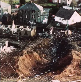  ?? (AP/Martin Cleaver) ?? This file photo shows wrecked houses and a deep gash that was caused by the crash of Pan Am Flight 103 in Lockerbie, Scotland, in December 1988.