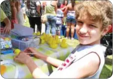  ?? Photo by Petra Chesner Schlatter ?? Landon Hsterlee, 12, of Morrisvill­e Borough took a break from decorating a yellow duck.