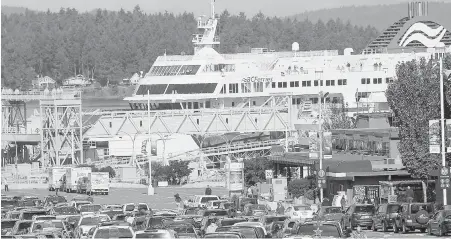  ??  ?? Vehicles line up for ferries at the busy Swartz Bay terminal. Starting Monday, smoking of all types is banned on B.C. Ferries’ vessels and at the ferry terminals.