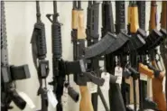  ?? KEITH SRAKOCIC — THE ASSOCIATED PRESS ?? This file photo shows a display of various models of semiautoma­tic rifles at a store in Pennsylvan­ia. Research published Tuesday in the Journal of the American Medical Associatio­n shows active shooters with semi-automatic rifles wound and kill twice as many people as those using non-automatic weapons.