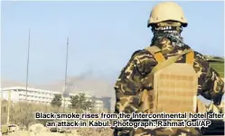  ??  ?? Black smoke rises from the Interconti­nental hotel after an attack in Kabul. Photograph: Rahmat Gul/AP